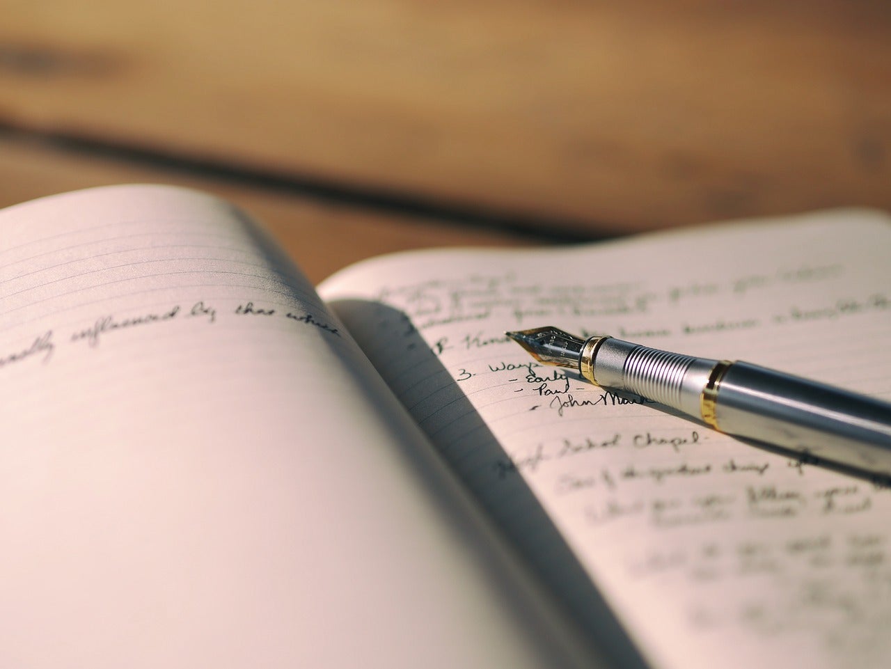 A notebook with writing produced by a fancy pen